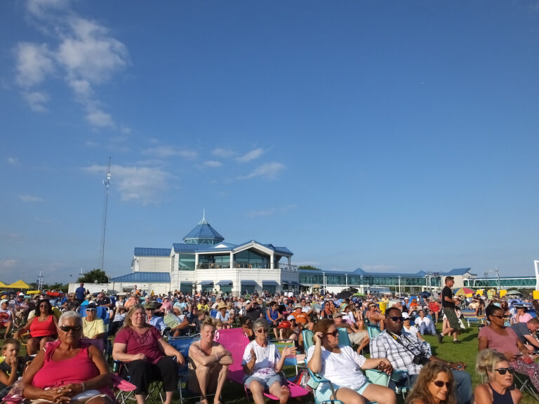 Concert-goers sit on their lawn chairs on the "green" next to the Cape May Ferry terminal