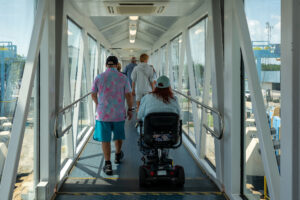 Passengers, including a ADA scooter, disembark from the Cape May - Lewes Ferry via the Skywalk into the Lewes Ferry Terminal where an Elevator is ready to transport the passenger to the ground level
