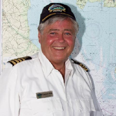 Head shot of Captain Richard McCann in uniform along with a black Cape May - Lewes Ferry cap