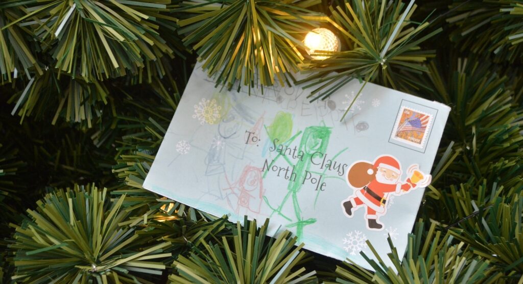 Handwritten letter to Santa placed in a Christmas Tree