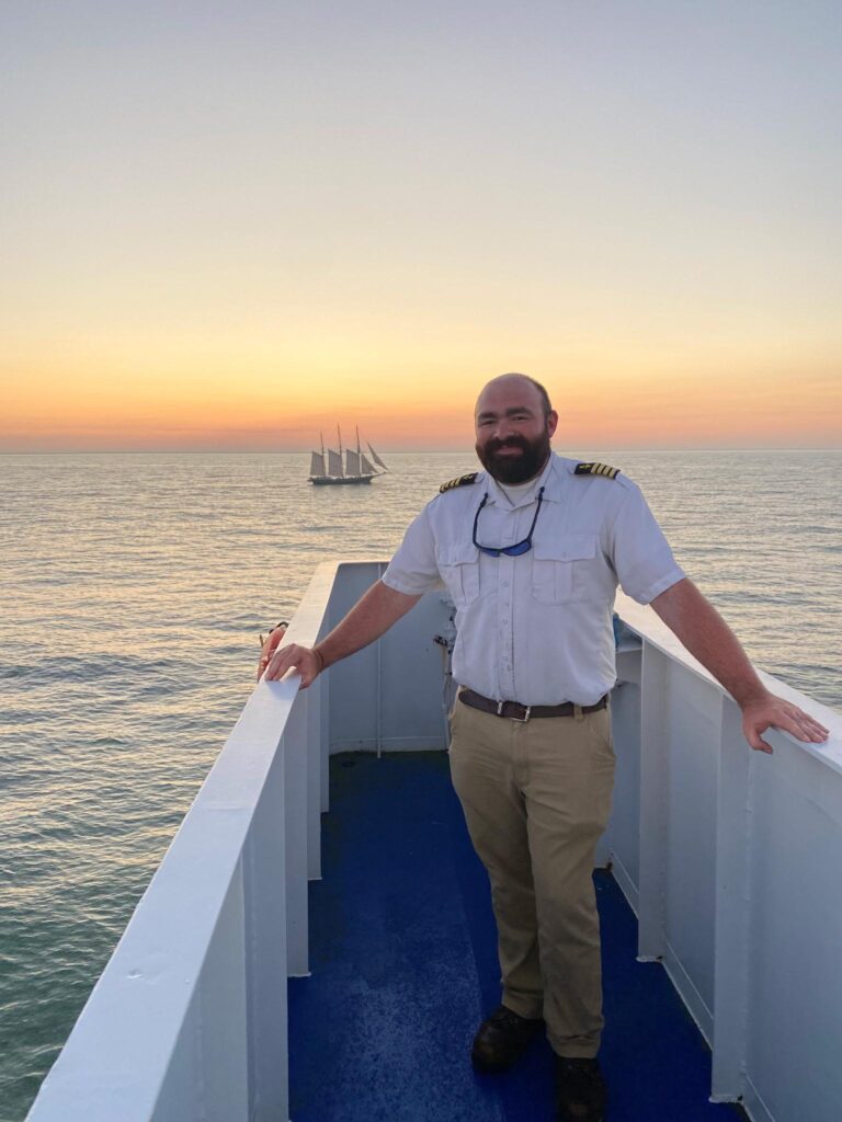 Captain Bowen standing in front of a sunset