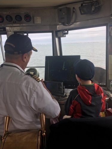 A photo of Captain Vance training a young wound-be sailor on the Bridge of the Cape May - Lewes Ferry